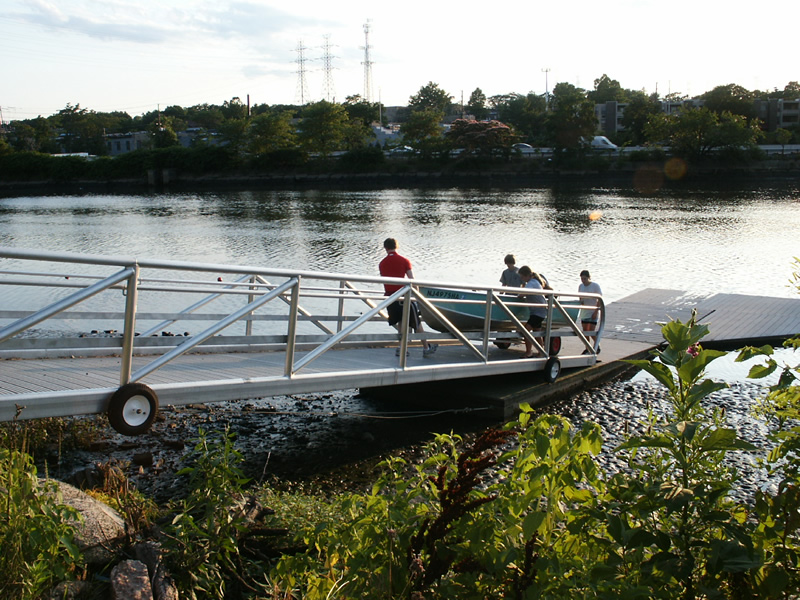Rolling the aluminum skiff up the gangway.